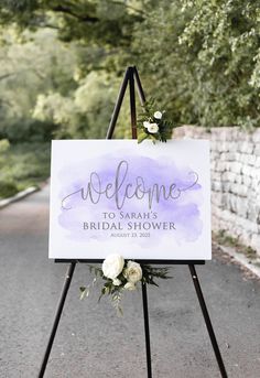 a welcome sign with flowers on it