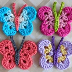 three crocheted butterflies sitting next to each other