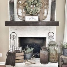 a living room filled with furniture and a fire place covered in a wreath on top of a mantel