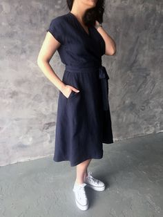 "Handmade loose wrap linen dress with short kimono sleeves, pockets and belt. Comfortable summer, swing dress from natural eco-friendly linen. Made with love for You. *100% local medium weight washed linen *Each item is individually cut and sewn by order *The model is wearing size L, dress color - Navy *The model height is 172 cm *Note that colors may look different on your display depending on their settings and technical characteristics. Please let us know if you need different measurements or V-neck Linen Dress For Workwear With Relaxed Fit, Relaxed Fit Linen V-neck Dress For Work, Indigo V-neck Summer Dress, Elegant V-neck Linen Dress With Pockets, V-neck Linen Midi Dress With Belt, Relaxed Fit V-neck Dress With Tie Waist, Relaxed Fit V-neck Linen Dress With Pockets, Relaxed Fit V-neck Linen Dress For Work, Indigo Dresses For Summer Workwear