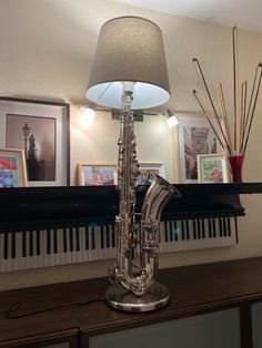 a silver musical instrument sitting on top of a wooden table