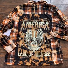 an orange and black flannel shirt that says america land of the free