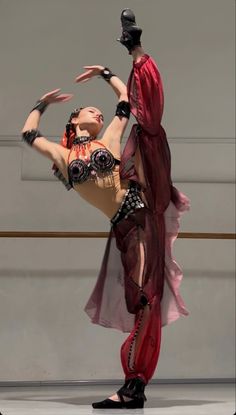 two women in costumes are performing on stage