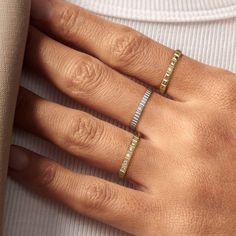 Introducing a trinity of elegance and symbolism: the stackable ring set that empowers you to narrate your story. The first ring, with its bullet-shaped, silver-hued craftsmanship, embodies resilience and strength—a testament to the fearless spirit. It's more than a ring; it's a shield of confidence, a declaration of fortitude that says you are invincible.The second ring, in lustrous gold, is an eternal band, set with stones that capture the everlasting essence of love and commitment. Each stone Timeless Adjustable Midi Rings For Promise, Timeless Style Adjustable Midi Promise Rings, Timeless Stackable Midi Rings For Anniversary, Adjustable Stackable Promise Rings, Timeless Adjustable Stackable Open Rings, Stackable White Gold Midi Rings, Timeless Adjustable Stackable Midi Rings, Timeless Stackable Promise Rings Tarnish Resistant, Silver Stackable Wedding Rings Tarnish Resistant