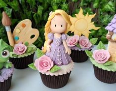 some cupcakes that have been decorated to look like princesses and froggies