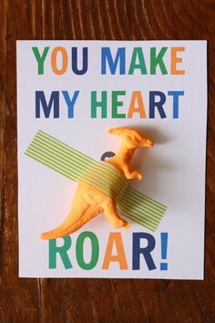 a card that says you make my heart roar with an image of a dinosaur on it