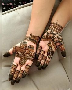 two hands with henna designs on them