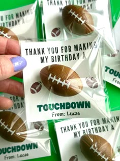 a hand holding a card that says thank you for making my birthday with footballs on it