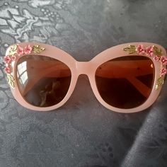 Pink Rosette Sunglasses Spring Pink Cat Eye Sunglasses With Uva Protection, Pink Cat Eye Sunglasses With Uva Protection For Party, Pink Cat Eye Sunglasses For Parties, Pink Cat Eye Sunglasses With Uva Protection For Spring, Pink Cat Eye Party Sunglasses, Elegant Pink Cat Eye Sunglasses For Spring, Party Pink Cat Eye Sunglasses, Retro Pink Sunglasses For Spring, Pink Glass Cat Eye Sunglasses For Summer