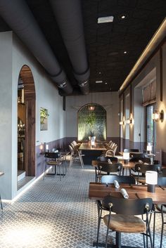 an empty restaurant with wooden tables and chairs