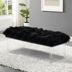 a black bench sitting on top of a white rug