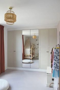 a bedroom with a large mirror and closets