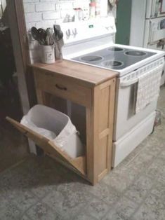 a white stove top oven sitting inside of a kitchen