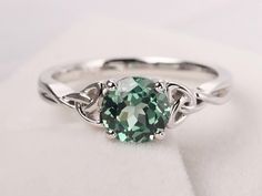 Welcome to my shop, you can find many beautiful gemstone jewelry here, and you also can ask for customized service. Main Stone: Lab green sapphire , round cut 7 mm Accent Stones: None Metal: 925 sterling silver plated with rhodium so as to protect the ring from tarnish and keep it shinning. I also can provide metal options such as 14k solid yellow/white/rose gold Setting: bezel setting more rings: https://www.etsy.com/shop/XCjewelryStudio?ref=hdr_shop_menu It's quite comfortable for wearing and Meaningful Rings, Sapphire Silver Ring, Celtic Engagement Rings, Green Sapphire Ring, Celtic Knot Ring, Celtic Rings, Knot Ring, Green Sapphire, Ring Unique