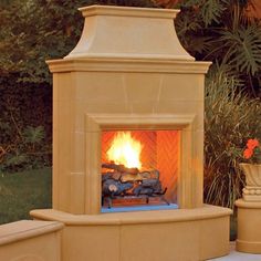 an outdoor fireplace in the middle of a patio