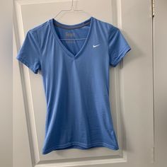 Women’s Nike Dri-Fit Blue Shirt Nwot Size Xsmall Bought And Never Wore Nike Fitted Casual Shirt, Sporty Blue Shirt, Fitted Blue Nike Tops, Sporty Light Blue Nike Tops, Nike Blue Crew Tops, Nike Blue Casual Shirt, Casual Blue Nike Shirt, Light Blue Fitted V-neck T-shirt, Casual Blue Nike T-shirt