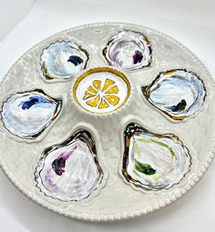 a white plate topped with different types of oysters