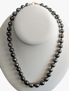 Embrace the allure of this exquisite Tahitian Pearls necklace, elegantly held together with a 14K Yellow Gold interlocking clasp. This beautiful necklace spans a length of 18" (~46cm), with a substantial weight of 47.8g, that affirms its quality and durability. The colors of these pearls are a testament to the wonders of nature. These cultured Tahitian pearls present a spectrum of 100% natural colors, including Purple, Cherry, and Green Cherry hues. These colors are further accentuated with char Tahitian Pearls Necklace, Cherry Light, Green Cherries, Tahitian Pearl Necklace, Pearls Necklace, Purple Light, Pearl Strands, Akoya Pearls, Tahitian Pearls