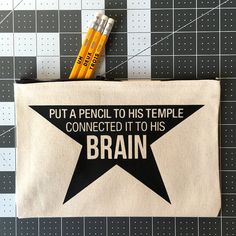 pencils are sitting on top of a canvas bag that says put a pencil, to his temple connected it to his brain