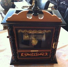 an antique clock is sitting on the table