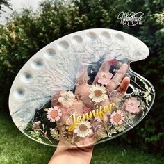 a person holding up a clear plate with flowers on it and the word summer written in large letters