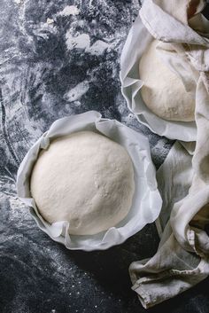 two uncooked round breads sitting on top of a table