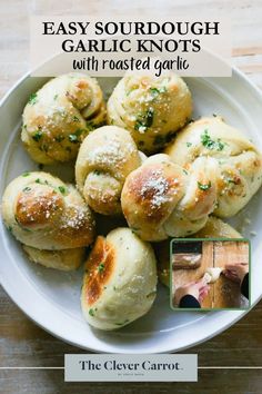 a white plate topped with rolls covered in cheese and sprinkled with parsley