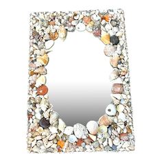 a mirror made out of rocks and shells