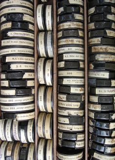 an old wooden box filled with lots of black and white typewriter's wheels