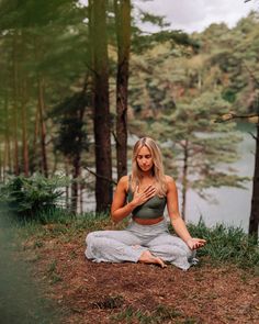 a woman sitting on the ground with her hands together