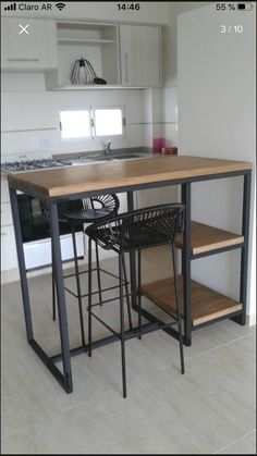 a kitchen with an island table and stools