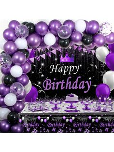 a purple and white birthday party with balloons