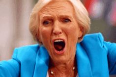 an older woman with her mouth open and hands in the air as she looks surprised