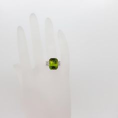 Gorgeous 10.95 ct. green sphene radiant and diamond round cocktail ring.  Handmade in 18k white gold.  Ring size is 6.5. Metal: White Gold Stone: Diamond Stone Cut: Radiant Cut  Dimensions reference the ring size and are not specific to the ring itself. Exact ring dimensions are not provided. Please reach in the seller Q&A for questions. Diamond Cocktail Ring, Diamond Cocktail Rings, Easter Shopping, Gold Stone, Radiant Cut, White Gold Ring, Stone Cuts, Ring Handmade, Diamond Stone