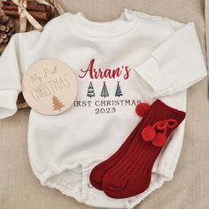 Our personalised Bauble Sweatshirt Romper is made out of premium quality fleece material and features First Christmas 2023 embroidery with your baby's name in the center. It comes in a beautiful gift box with an option of adding matching socks and 'First Christmas' wooden milestone sign. This Christmas Romper will make a perfect sentimental First Christmas Present as well as cute and toasty Christmas Outfit.  Romper Sizes: 0-3 m  3-6 m 6-9  m 9-12m Socks come in red or green colour and one size Christmas Baby Outfits, Baby Christmas Outfits, Onesie Diy, 2023 Embroidery, My First Christmas Outfit, Wooden Milestone, Sweatshirt Romper, First Christmas Baby, Christmas Romper