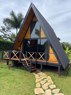 a - frame cabin with stairs leading up to it