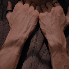 two hands on the back of a person's chest, both holding their hands together