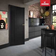 a kitchen with brick walls and black cabinets