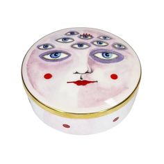 a white box with blue eyes and red polka dots on the lid is shown in front of a white background