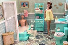 a doll house bathroom with two dolls in it