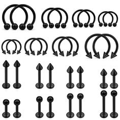 an assortment of black metal nose rings with arrows on each one side and the other end