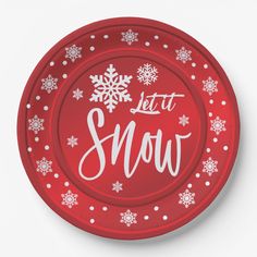 a red paper plate with snow written on the side and white snowflakes around it