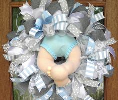 a blue and gray wreath with a baby's diaper on it