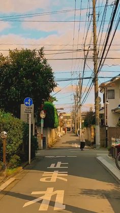 an empty street with power lines above it