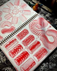 a drawing book with red and white designs on it