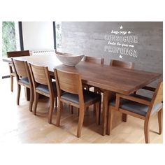 a dining room table with chairs and a bowl on top