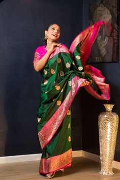 This gorgeous saree is made of high-quality Katan Banarasi silk, flaunting a stunning green hue with exquisite golden floral motifs and a beautiful pink border. Indulge in luxury and elegances with this timeless classic. Green Tussar Silk Traditional Wear, Green Paithani Silk Lehenga With Self Design, Green Tussar Silk Saree With Meenakari, Green Paithani Silk Lehenga For Festivals, Green Meenakari Tussar Silk Saree, Bollywood Style Dark Green Cutdana Dupatta, Bollywood Style Dark Green Dupatta With Cutdana, Green Katan Silk Traditional Wear, Dark Green Bollywood Dupatta With Cutdana