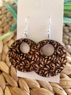 the earrings are made out of wood and have intricate designs