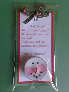 a christmas card with a snowman ornament in the shape of a button