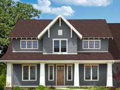 a house with gray siding and white trim